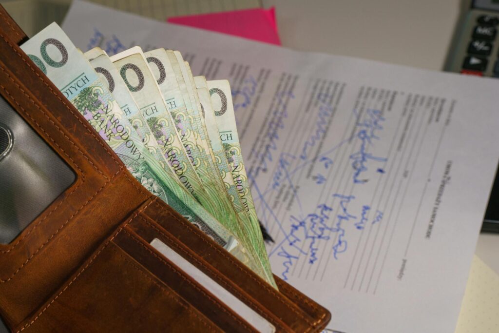 stały zasiłek z pomocy społecznej – portfel z banknotami euro i dokumentem